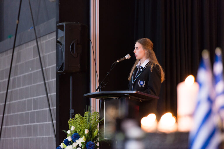 High School student speaking at the podium on the stage.